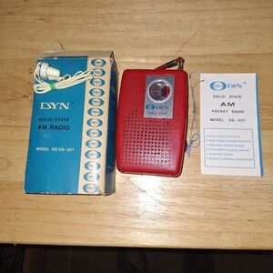 DayN Solid State Red AM Pocket Radio With Box, Directions, and Earphones.
